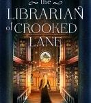 Cover of The Librarian of Crooked Lane. Back of woman with long blond hair and a black dress, standing in the lobby of a library with bookshelves on either side of her and a clock in front of her on a wall.